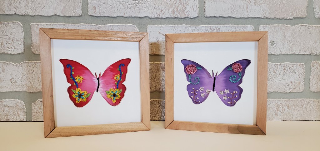 Examples of butterfly silhouettes with wings extended. Embroidered floral designs on the inside.