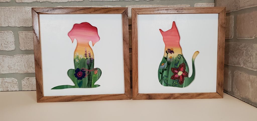 Dog and Cat sitting silhouettes with sunset sky background. Embroidered flower details.