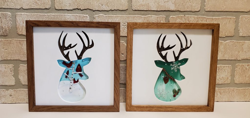 Antler deer head profile silhouettes with winter scenes and embroidered cardinals, trees, snowflake details.