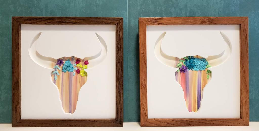 Longhorn skull silhouette with pastel color background with embroidered cactus and flower details