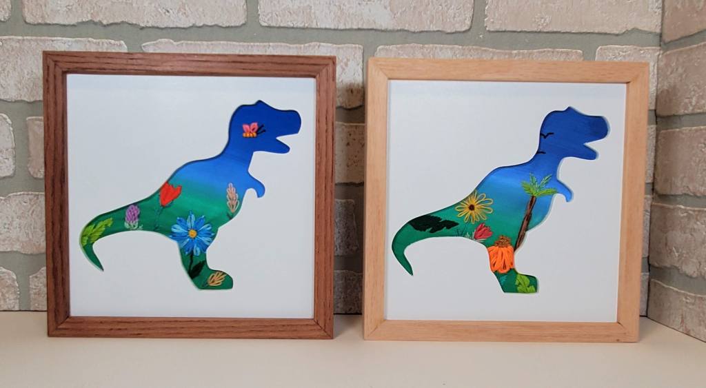 examples of a side view T-Rex silhouette with a blue background and embroidered flower details.