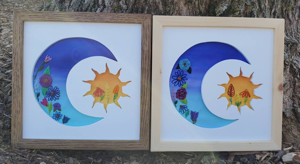 Crescent moon and sun silhouette with embroidered flower details.