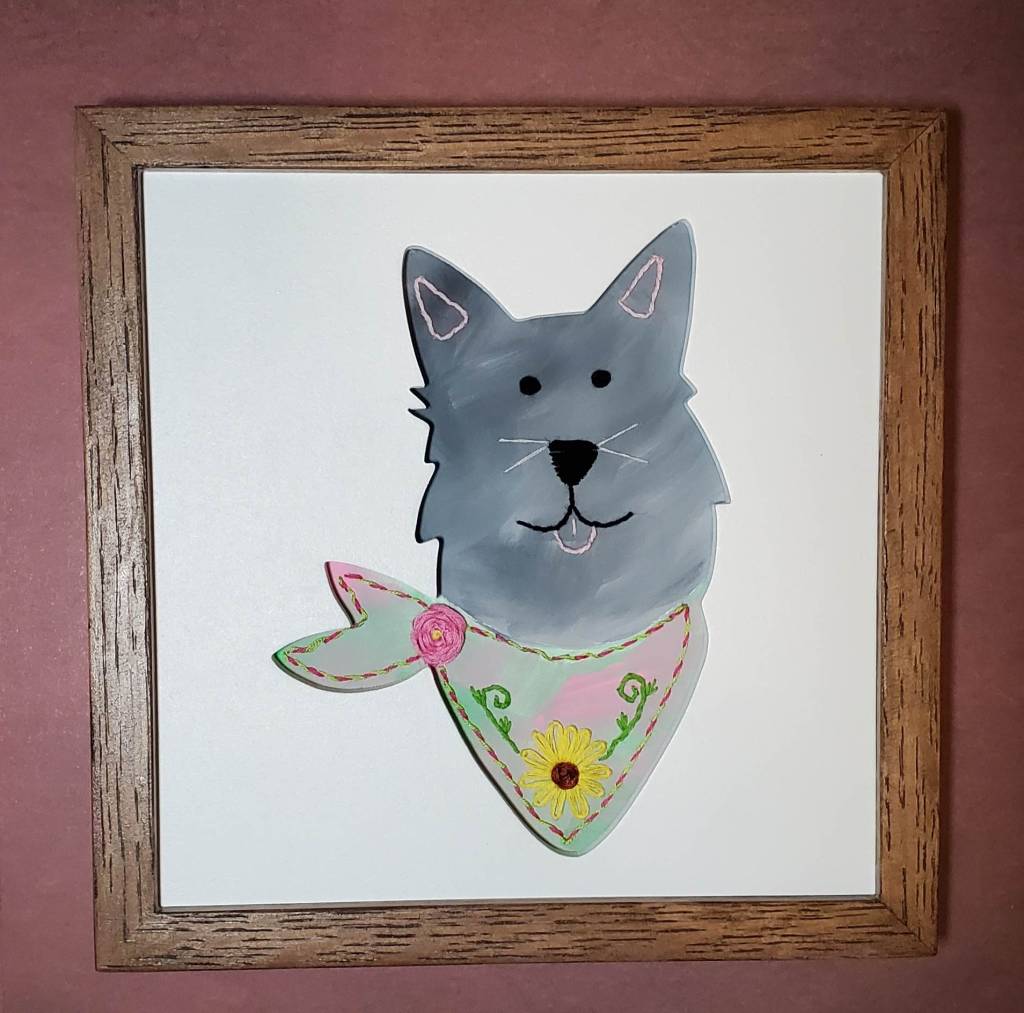 Pointy eared dog face silhouette. Gray dog with pink bandana, embroidered flower details.